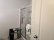 Tiled shower with glass door and white trim at 320 Aberdeen Dr, Davenport, FL 33896
