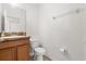 Well-maintained half bathroom features wood vanity, laminate countertop, a toilet, and neutral-toned walls at 3610 Rodrick Cir, Orlando, FL 32824