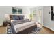 Comfortable bedroom with neutral décor, a large window for natural light, a queen-size bed, and stylish furnishings at 3610 Rodrick Cir, Orlando, FL 32824