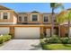Charming two-story townhome showcasing a two-car garage, neat landscaping, and a welcoming front entrance at 3610 Rodrick Cir, Orlando, FL 32824