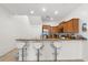 Bright, eat-in kitchen featuring stainless steel appliances, breakfast bar with seating, wood cabinets, and tile flooring at 3610 Rodrick Cir, Orlando, FL 32824