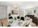 Elegant living and dining area features modern décor, a marble dining table, plush seating, and stylish accents at 3610 Rodrick Cir, Orlando, FL 32824
