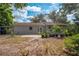 The backyard features a cozy patio, potted plants and healthy-looking foliage at 412 Noya Ln, Apopka, FL 32712