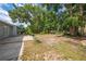 Backyard featuring a combination of dirt, grass, foliage and a concrete patio at 412 Noya Ln, Apopka, FL 32712