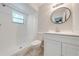 Bright bathroom featuring a shower, vanity, commode, and mirror at 412 Noya Ln, Apopka, FL 32712