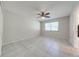 Neutral bedroom featuring tile floors, a ceiling fan, and a window at 412 Noya Ln, Apopka, FL 32712
