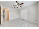 Cozy bedroom with neutral tones, tile flooring, a ceiling fan and a closet at 412 Noya Ln, Apopka, FL 32712