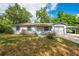 Charming single-story home featuring a well-maintained lawn, covered garage, and quaint front entrance at 412 Noya Ln, Apopka, FL 32712