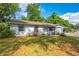 Charming single-story home featuring a well-maintained lawn, covered garage, and quaint front entrance at 412 Noya Ln, Apopka, FL 32712