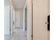 Hallway with tile floors, neutral walls and bright white doors to bedrooms and bathrooms at 412 Noya Ln, Apopka, FL 32712