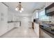 Modern kitchen with stainless steel appliances, granite counters, and breakfast bar for entertaining at 412 Noya Ln, Apopka, FL 32712