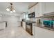 Bright kitchen with stone backsplash, stainless steel appliances and granite counters, perfect for cooking at 412 Noya Ln, Apopka, FL 32712
