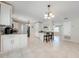 Bright, open kitchen featuring white cabinetry, granite countertops, and stainless steel appliances at 412 Noya Ln, Apopka, FL 32712