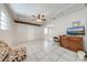 Open living area with tile floors, ceiling fan, and an arched doorway to another room at 412 Noya Ln, Apopka, FL 32712
