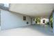Large, covered patio, showcasing a gray floor and view of the backyard and storage building at 412 Noya Ln, Apopka, FL 32712