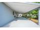 Spacious covered patio area with a gray painted surface, providing an ideal outdoor living space at 412 Noya Ln, Apopka, FL 32712