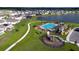 An aerial view of a planned community with a pool, playground, parking, and pond at 4190 Bull St, St Cloud, FL 34772