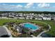 A beautiful view of a community pool, playground, parking area, and many homes at 4190 Bull St, St Cloud, FL 34772