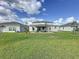 A spacious backyard features a covered patio, great for outdoor relaxation at 4190 Bull St, St Cloud, FL 34772