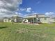 A spacious backyard features a covered patio, great for outdoor entertaining at 4190 Bull St, St Cloud, FL 34772