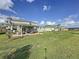 A spacious backyard features a covered patio, perfect for outdoor living at 4190 Bull St, St Cloud, FL 34772