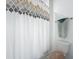A full bathroom with decorative shower curtain and towel rack at 4190 Bull St, St Cloud, FL 34772