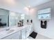 Bright bathroom with double sinks, quartz countertops, and a glass shower at 4190 Bull St, St Cloud, FL 34772