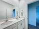Bathroom featuring double sinks with granite countertops and a large mirror at 4190 Bull St, St Cloud, FL 34772