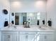 Bathroom featuring double sinks, quartz countertops, and a glass shower at 4190 Bull St, St Cloud, FL 34772