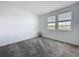 Bright bedroom with carpeting and two windows for natural light at 4190 Bull St, St Cloud, FL 34772