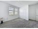 A cozy bedroom includes plush carpeting, closet, and windows for natural lighting at 4190 Bull St, St Cloud, FL 34772