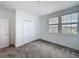 This bedroom features plush carpeting, a closet, and two windows for ample natural light at 4190 Bull St, St Cloud, FL 34772