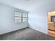 Well-lit bedroom featuring carpet flooring, a double window, and an ensuite bathroom at 4190 Bull St, St Cloud, FL 34772