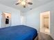 Bright bedroom with a ceiling fan, carpet flooring, and an ensuite bathroom and walk-in closet at 4190 Bull St, St Cloud, FL 34772