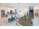 Bright dining area with white cabinets, breakfast bar and seating for four; view of stairs at 4190 Bull St, St Cloud, FL 34772