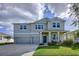 Attractive two-story home featuring a two-car garage, covered entry, and lush, green landscaping at 4190 Bull St, St Cloud, FL 34772