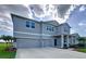 Elegant two-story home featuring a two-car garage, covered entry, and beautifully landscaped yard at 4190 Bull St, St Cloud, FL 34772