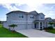 Elegant two-story home with a two-car garage, covered entry, and lush, green landscaping at 4190 Bull St, St Cloud, FL 34772