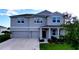 Attractive two-story home featuring a two-car garage, covered entry, and well-kept lawn at 4190 Bull St, St Cloud, FL 34772