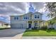 Charming two-story home with a two-car garage, covered porch, and neatly manicured lawn at 4190 Bull St, St Cloud, FL 34772