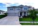 Charming two-story home featuring a spacious driveway, manicured lawn, and inviting covered porch at 4190 Bull St, St Cloud, FL 34772