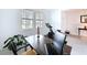 Open home office with natural light, Peloton, desk, and views to the entryway at 4190 Bull St, St Cloud, FL 34772