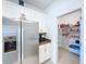 Modern kitchen with stainless steel appliances, white cabinets, and a well-stocked pantry at 4190 Bull St, St Cloud, FL 34772