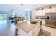 Open-concept kitchen with a large island, stainless steel appliances, and a view of the living area at 4190 Bull St, St Cloud, FL 34772