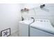 Bright laundry room features white appliances and storage shelf for convenience at 4190 Bull St, St Cloud, FL 34772