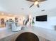 Bright living room with a view of the kitchen, stairs, and a large TV for entertaining at 4190 Bull St, St Cloud, FL 34772