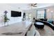 Cozy living room with neutral colors, a large TV, and a seamless connection to the outdoor space at 4190 Bull St, St Cloud, FL 34772