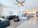 Open-concept living room with modern furnishings, tile flooring, and seamless flow into the kitchen at 4190 Bull St, St Cloud, FL 34772