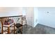 Upstairs loft area with neutral carpeting, wrought iron details, and natural light at 4190 Bull St, St Cloud, FL 34772