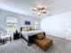 Comfortable bedroom with natural light, and neutral tones with a wooden chair and a large bed at 4190 Bull St, St Cloud, FL 34772